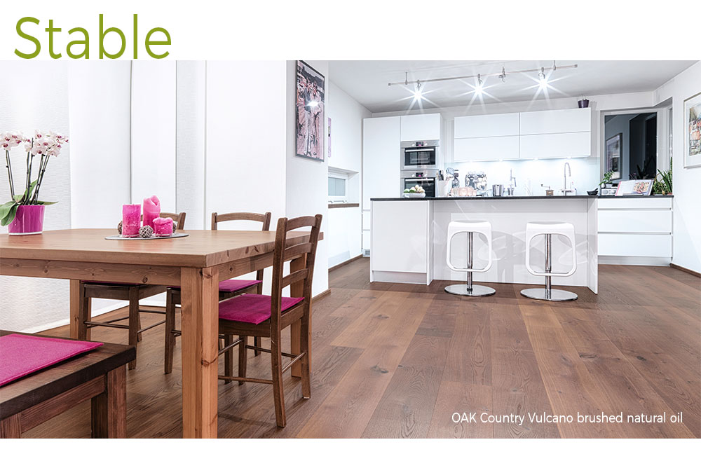 mafi Oak Country Vulcano brushed natural oil wood floors in a white, modern kitchen with a dark wood kitchen table and fuchsia pink accents
